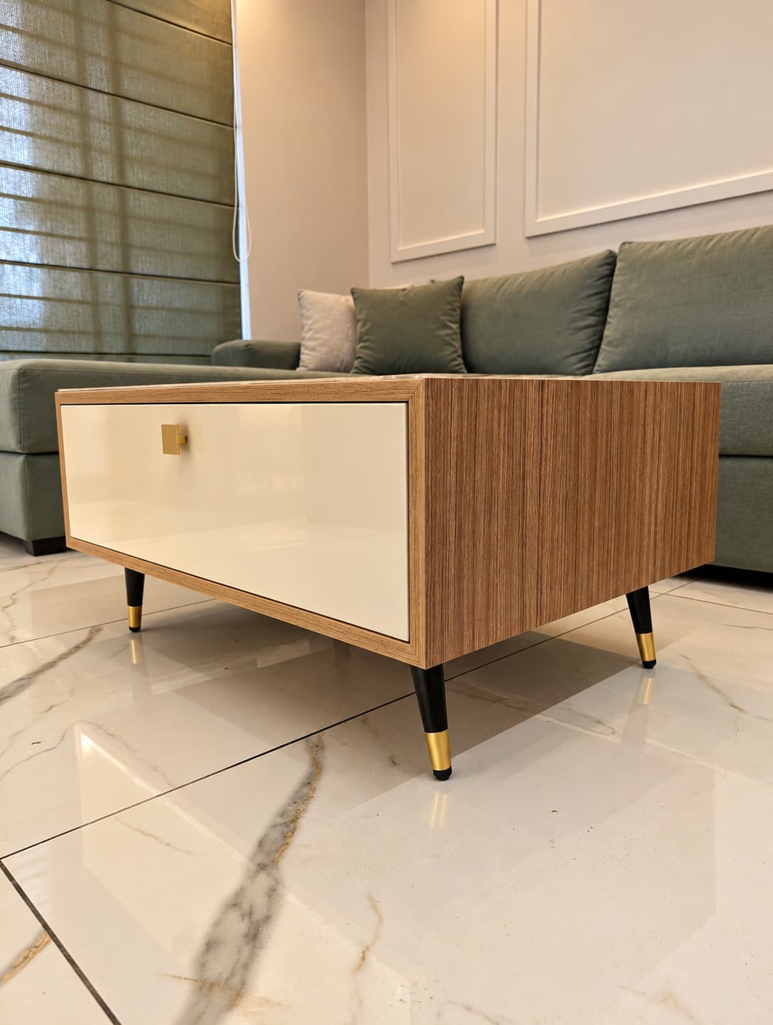 Timber and cream coffee table beside muted green seating