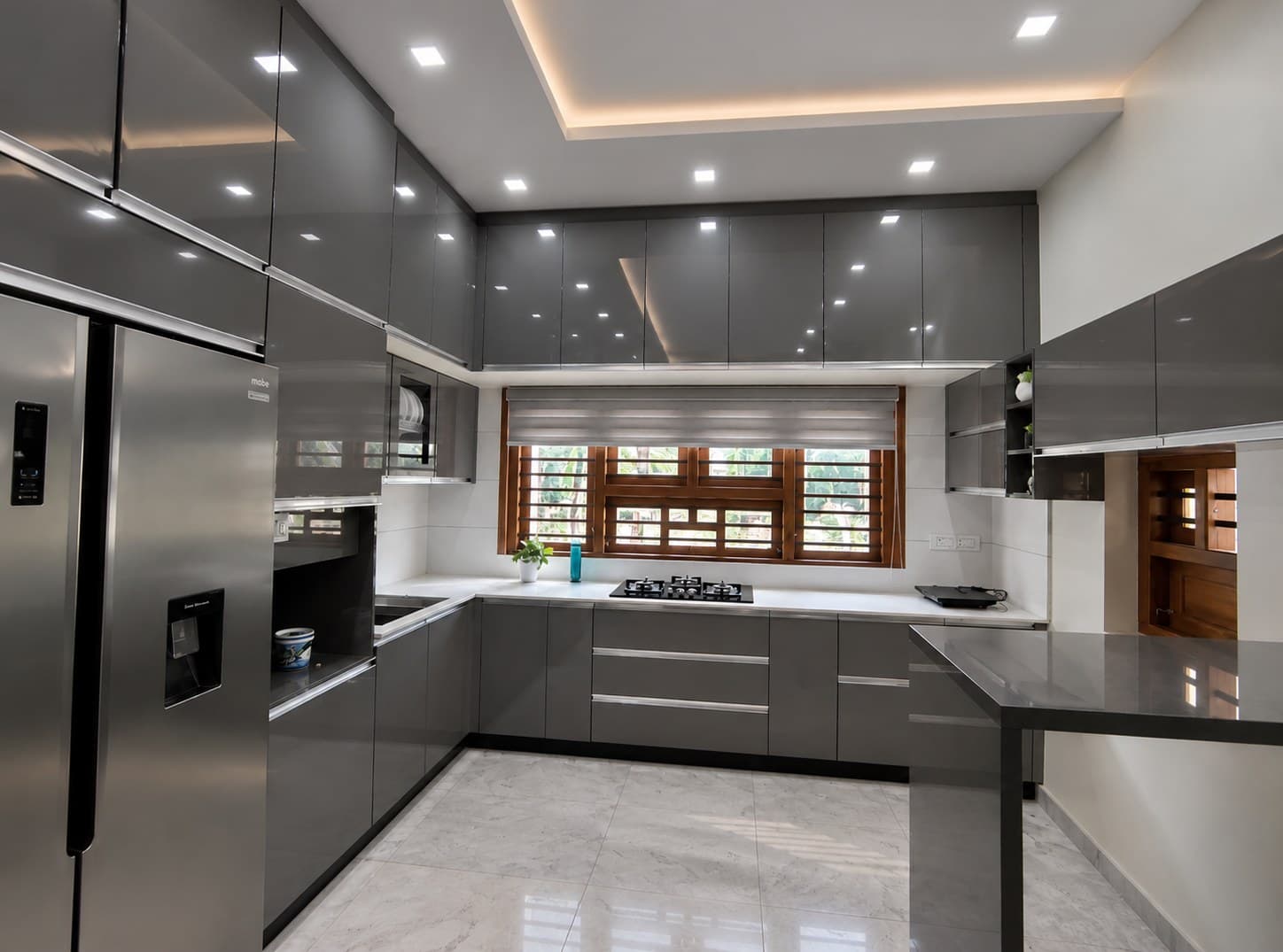 The contemporary charcoal-grey kitchen at Mr. Arshad’s Residence in Pookkottur
