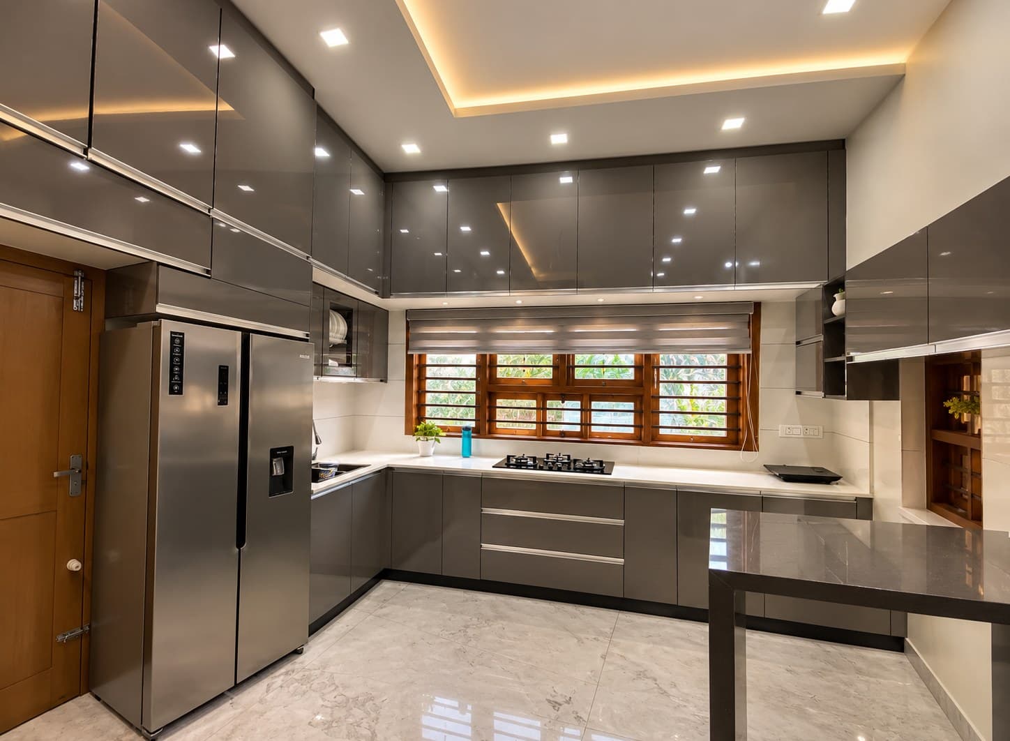 Wide view of the charcoal-grey modular kitchen and central window at Mr. Arshad’s Residence